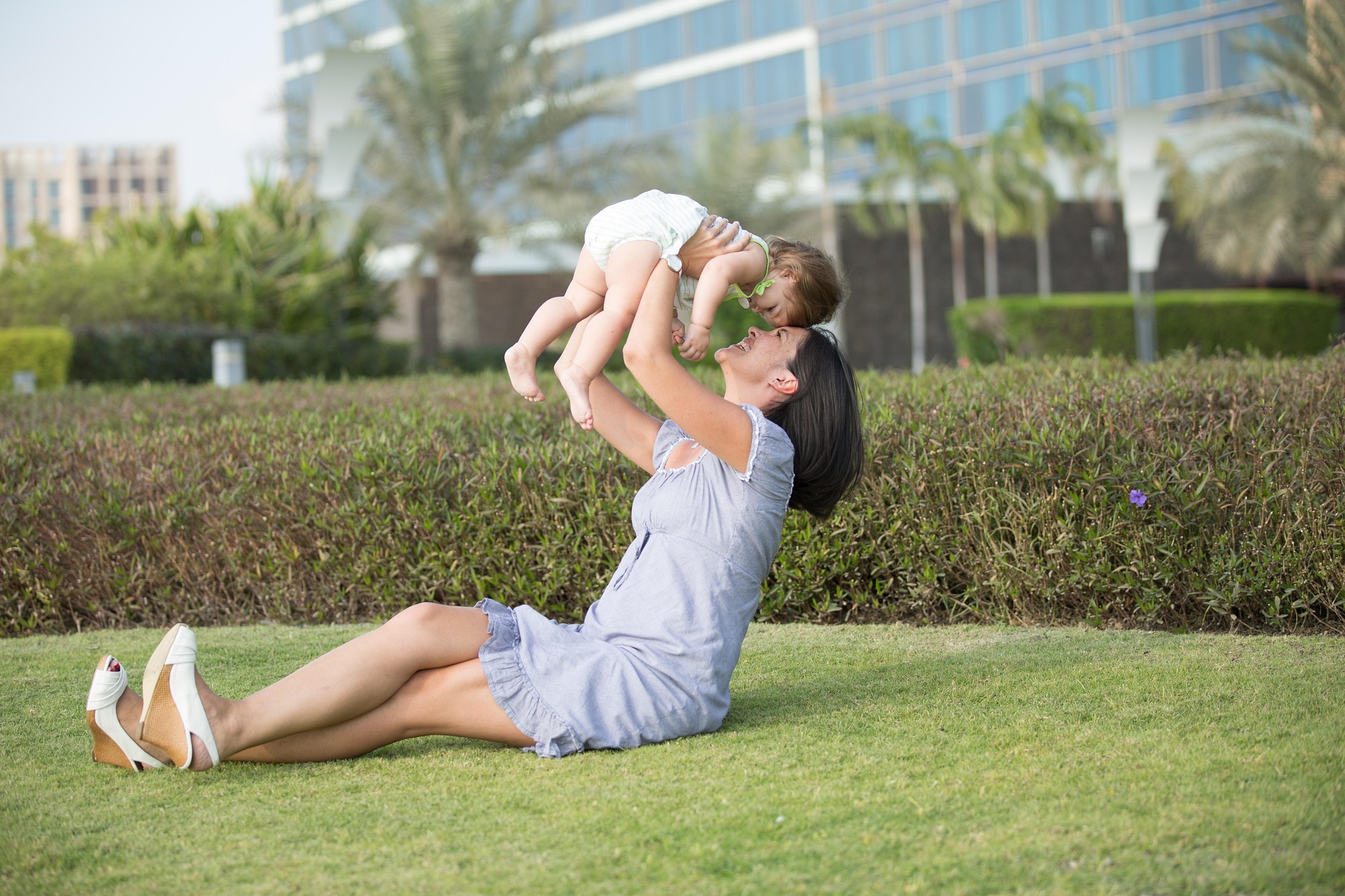Caregiver playing outside with a baby