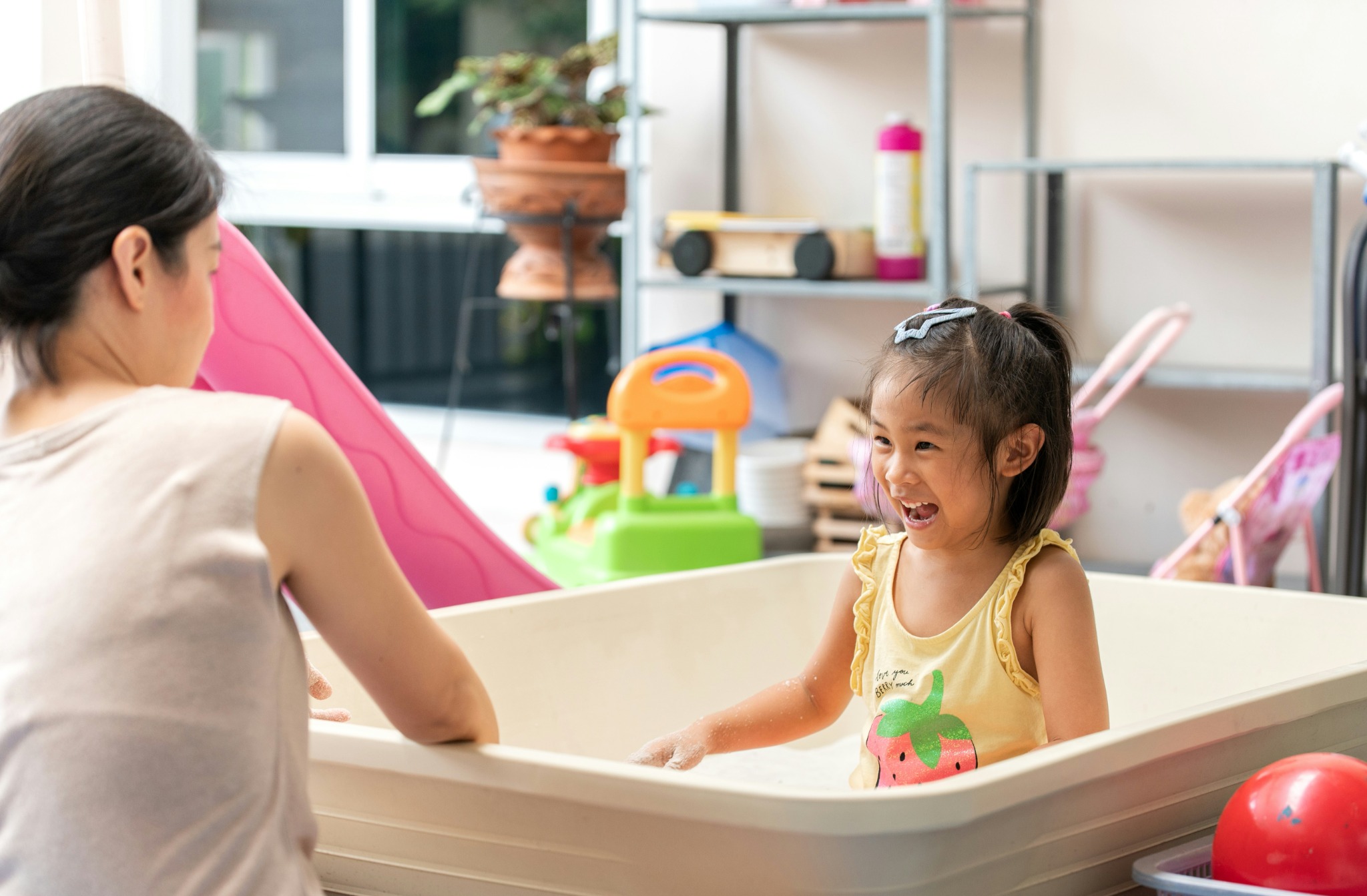 Caregiver playing with a child indoors